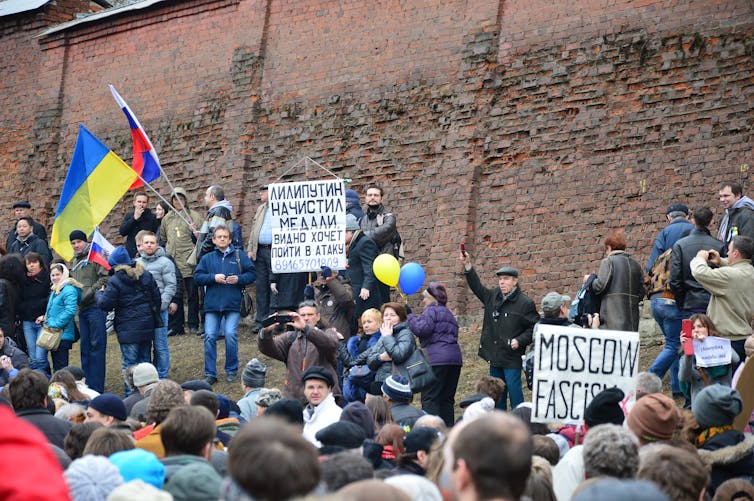 Protesters in Moscow with posters and Russian and Ukrainian flags on anti-war march in 2014..