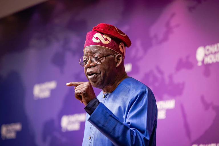 A man in traditional attire, speaking