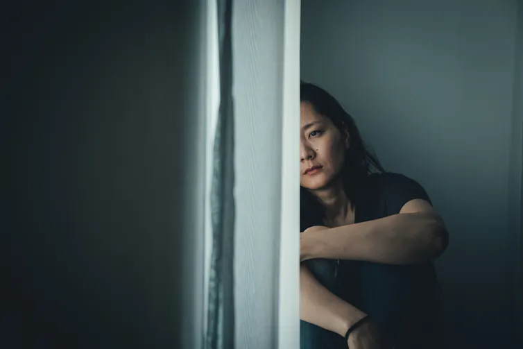 Woman sat looking sad
