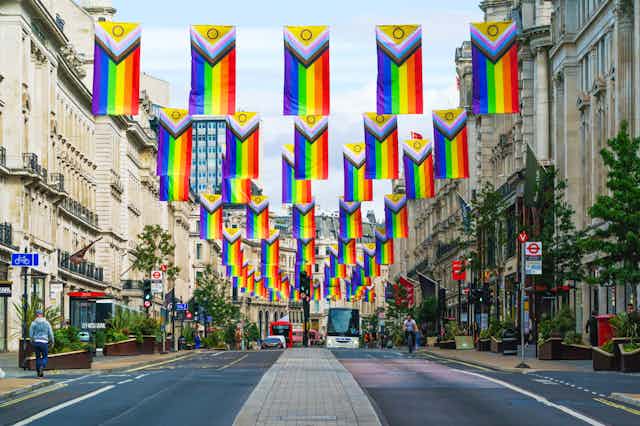Rows of inclusive Pride flags hang across a London street