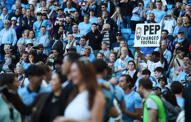 a fan holding a sign that says