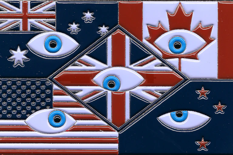 A coin depicting the 5 nation flags in of the Five Eyes alliance