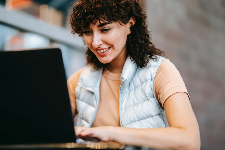 A woman works on a laptop.