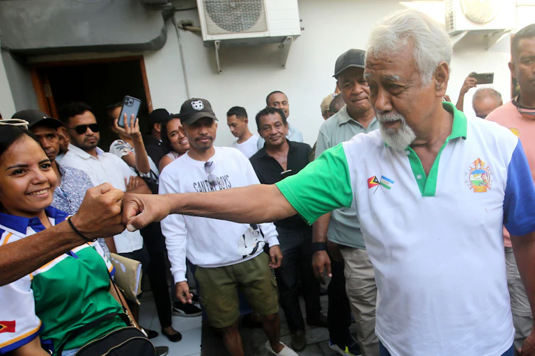 CNRT party leader and former independence fighter, Xanana Gusmao, bumps fifts with a supporter during the 2023 election campaign in East Timor.