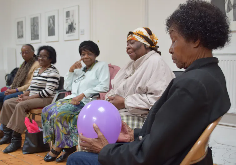 Ladies are seated in a row.