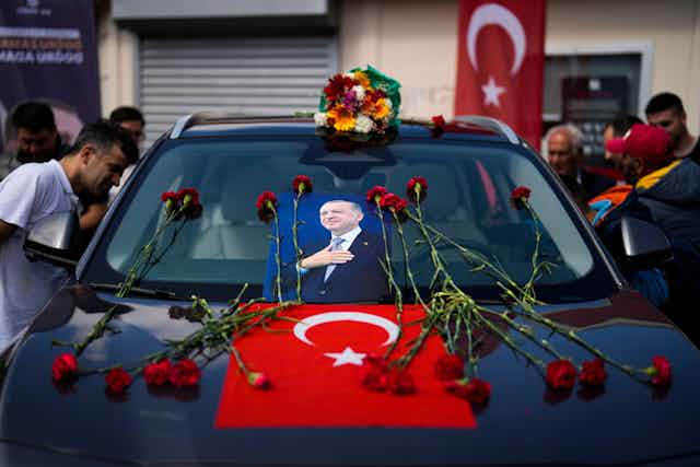 A car covered with carnations and a picture of presidential candidate Recep Tayyip Erdogan. 