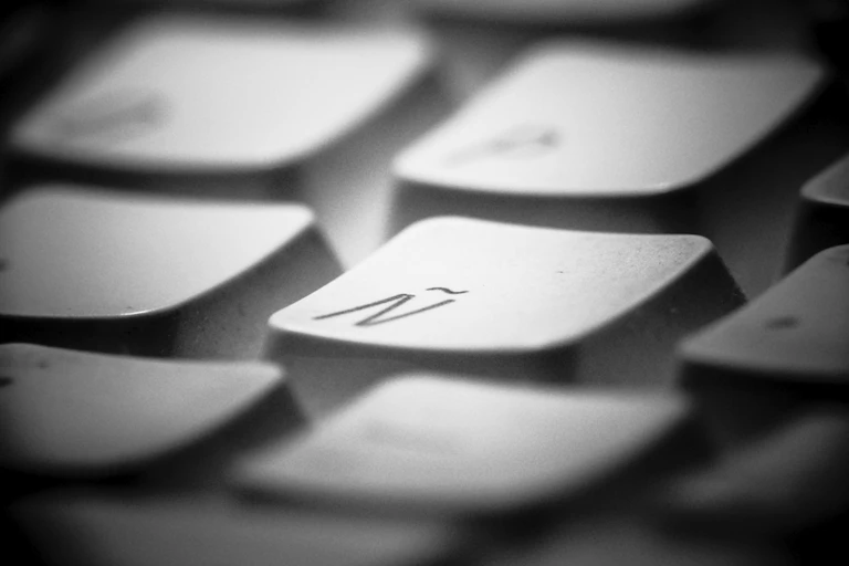 A blurred keyboard with the letter ñ in focus.