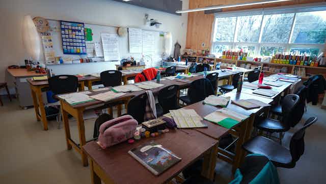 Desks seen in a classroom.