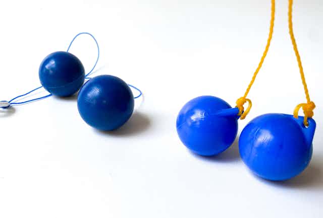 Two sets of blue clacker-ball toys