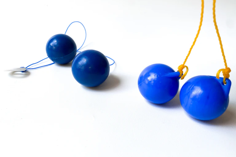 Two sets of blue clacker-ball toys