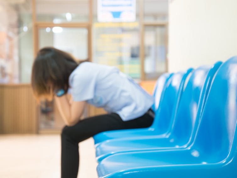 Woman sits in waiting room