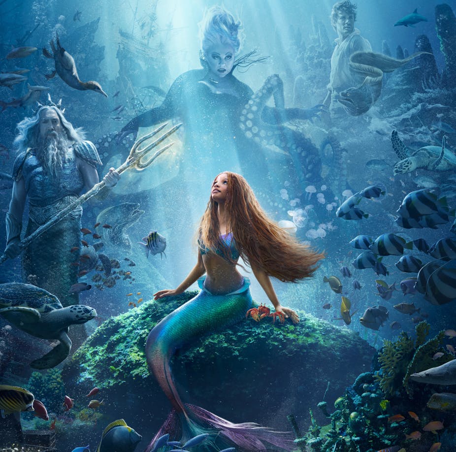 Halle Bailey as Ariel with mermaid tail under the sea. 