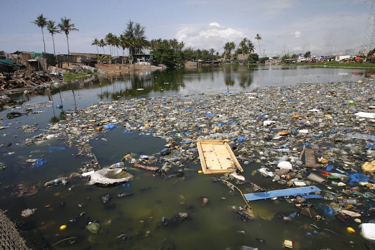 A river with floating plastic waste.
