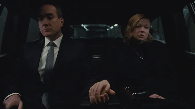 Tom (Matthew Macfadyen) and Shiv (Sarah Snook) loosely holding hands in a car.