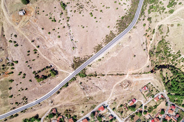 An overhead shot of a Greek landscape with a road running through.
