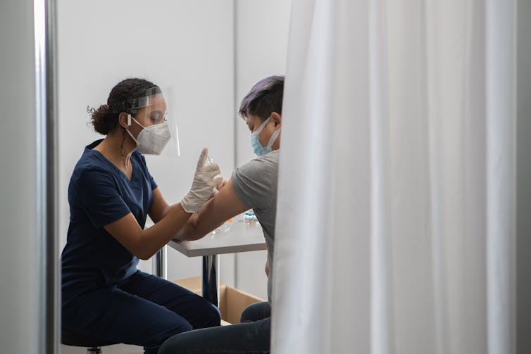 Clinician vaccinates man