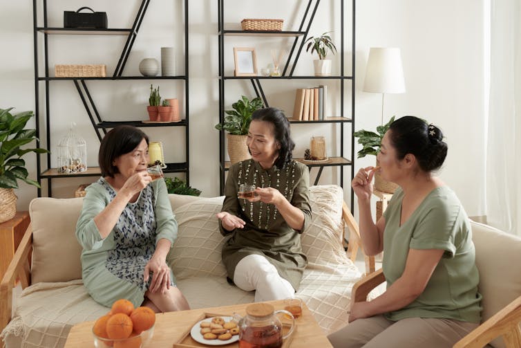 Three women drink tea