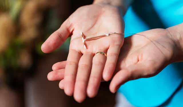 Woman holds an IUD