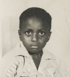 A young Jamaican boy looking serious in his passport picture.