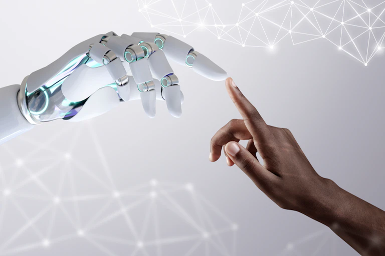 a human hand reaches out to touch a robotic hand