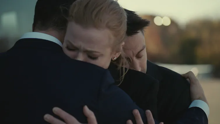 The Roy siblings embrace each other.