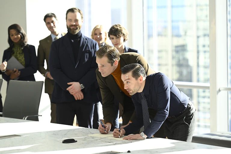 Characters from Succession signing a deal
