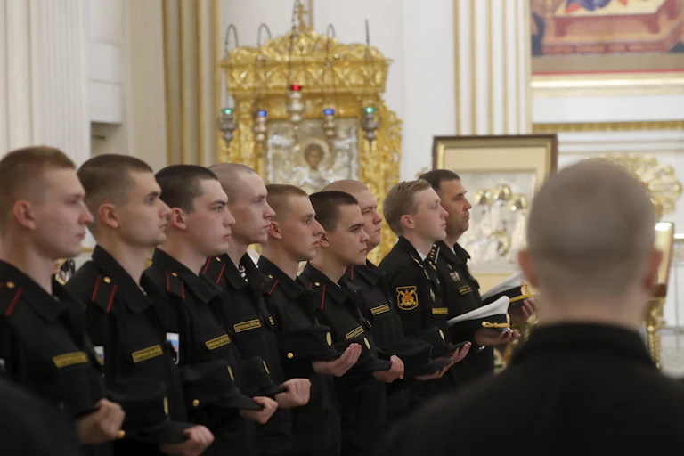 Russian marine conscripts stand in a line in St Petersburg cathedral.