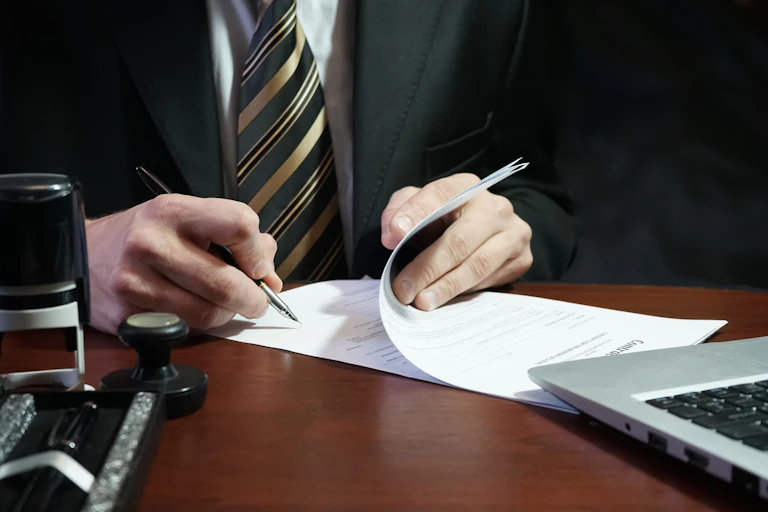 businessperson signing document.