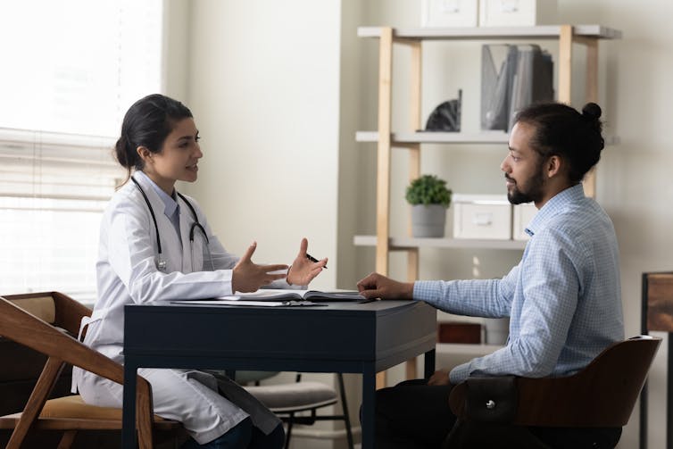 Female doctor speaks with male patient.