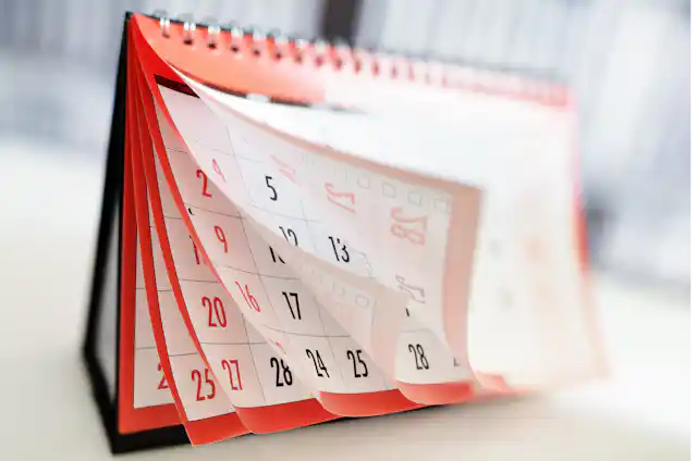 The pages of a calendar in motion.