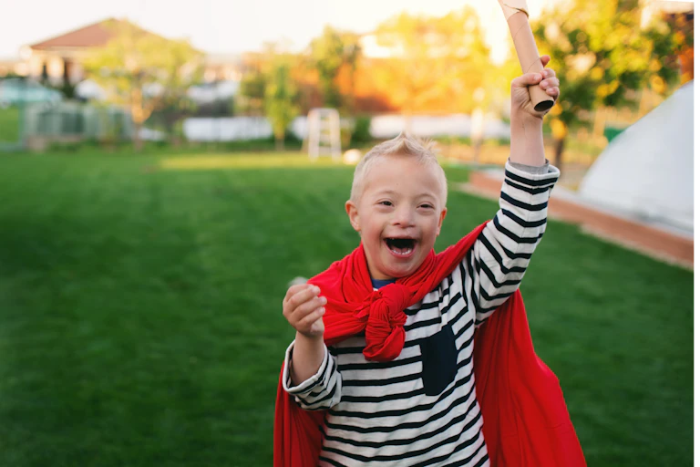 Child with Down syndrome playing outside