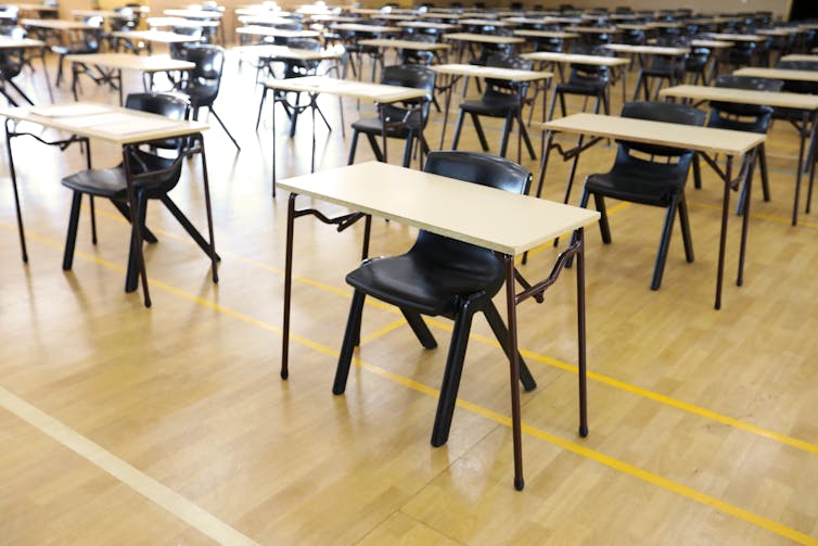 Desks lined up in an exam hall.