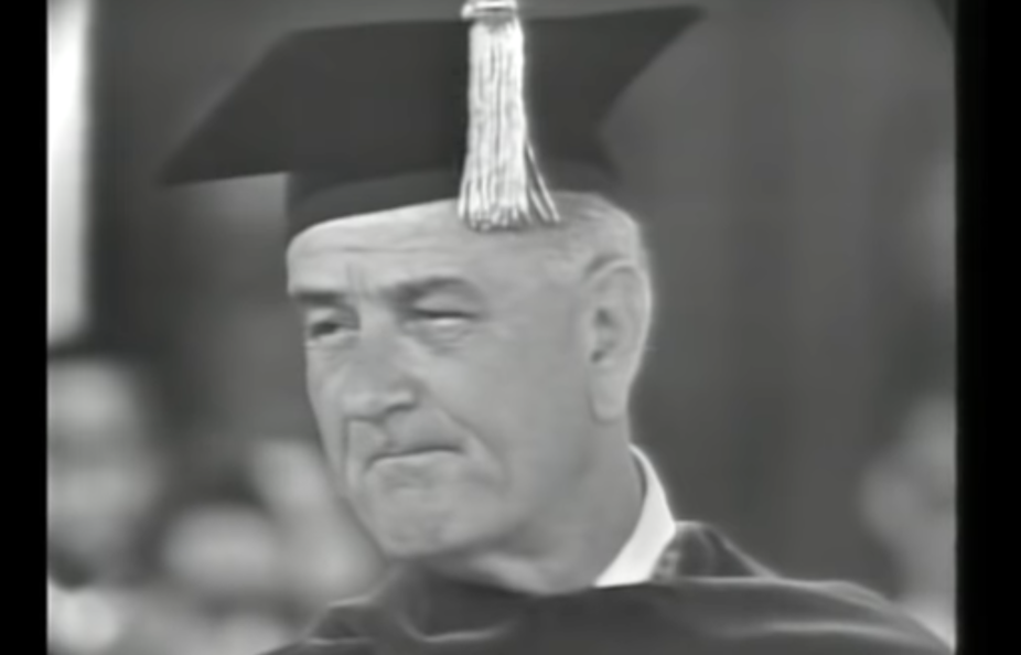 An elderly white is speaking at a college graduation.