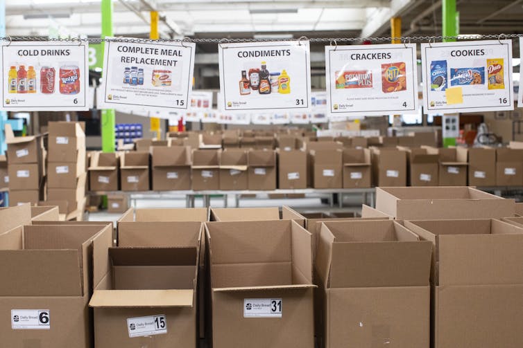 Empty cardboard boxes stacked in a well-lit warehouse.