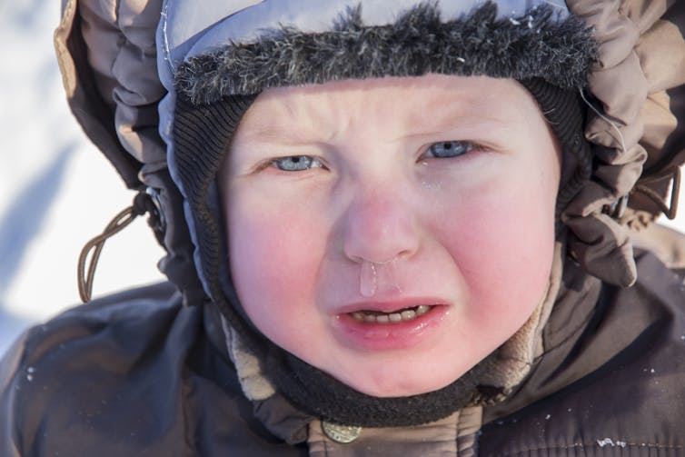 child crying in winter setting with mucus coming from nose