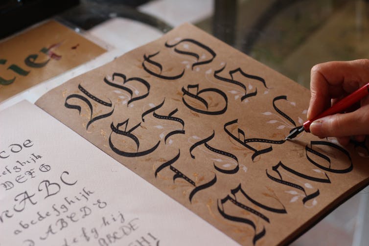 A book with a calligraphy alphabet.