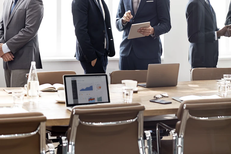 Businesspeople standing around meeting table