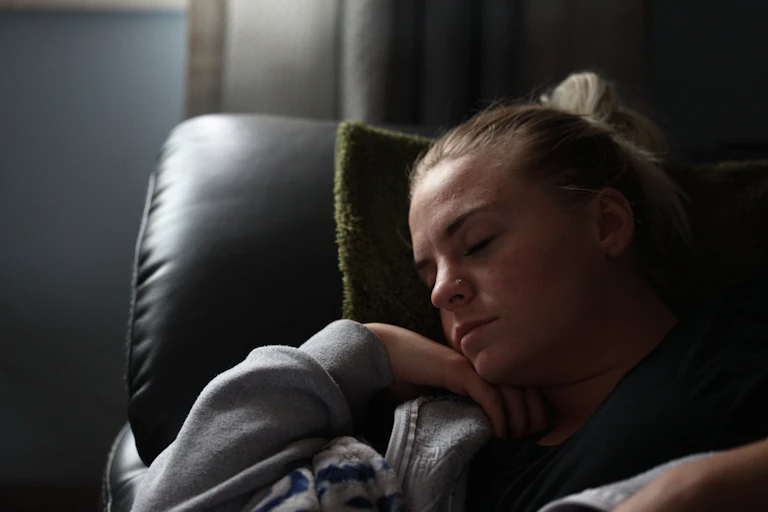Woman sleeps on a sofa