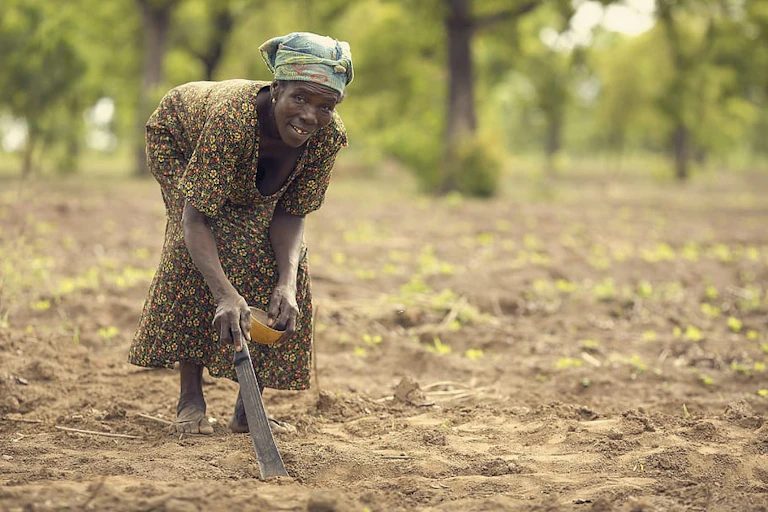 A woman holding a cutlass