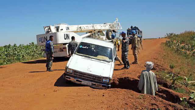 A UN truck stops to help a car in trouble in Dafur, Sudan in 2019.