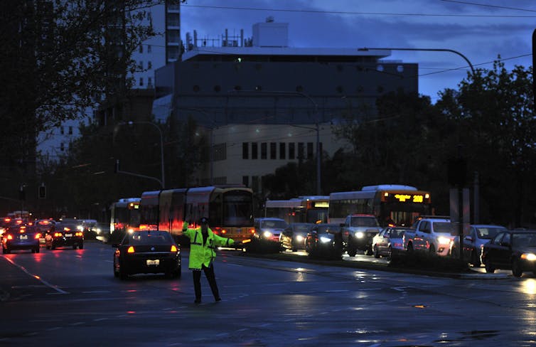 policeman directs traffic during blackout