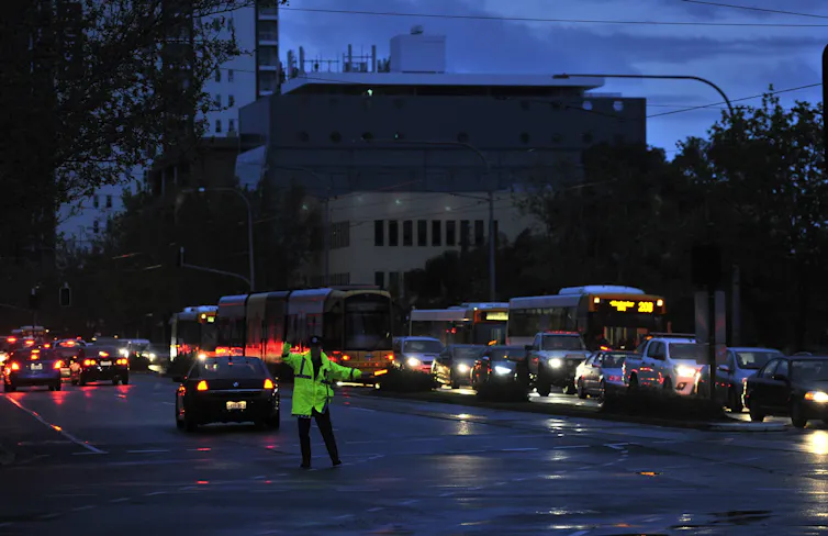 policeman directs traffic during blackout