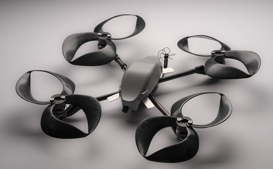 A black drone with four pinwheel shaped propellers with closed blades