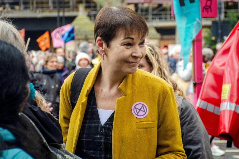Caroline Lucas walking in a crowd