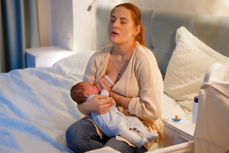 Woman tired breastfeeding