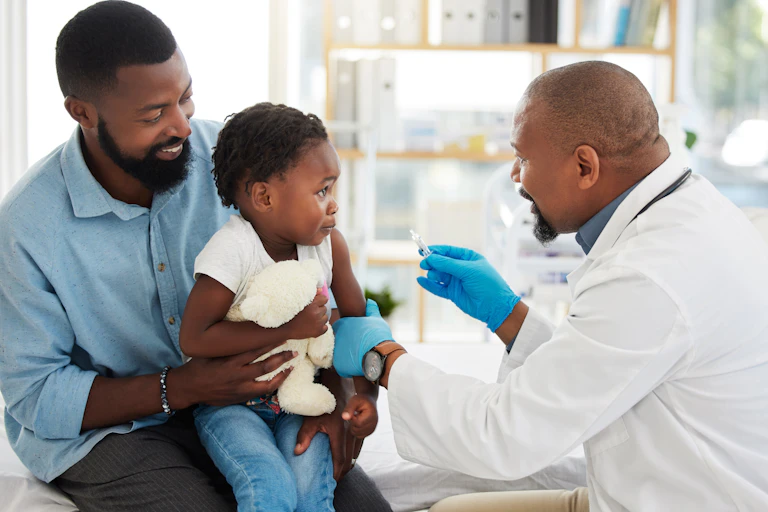parent holding a child getting vaccinated