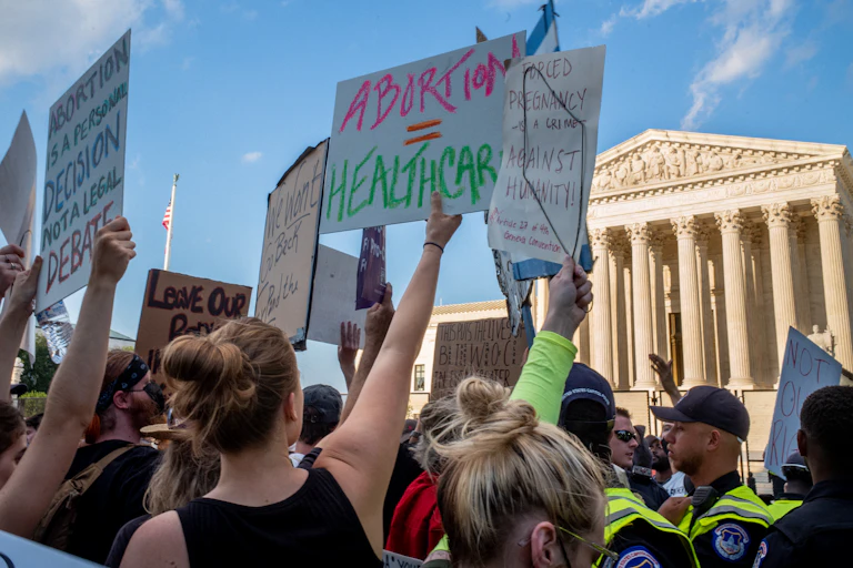 A horde of people, holding signs that call for abortion rights above the heads, protest in from of the U.S. Supreme Court.