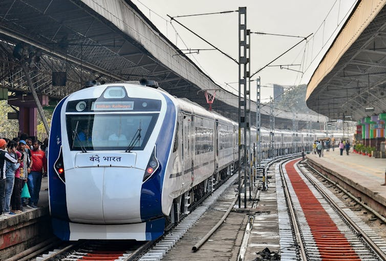 A modern high-speed train is seen in a station.