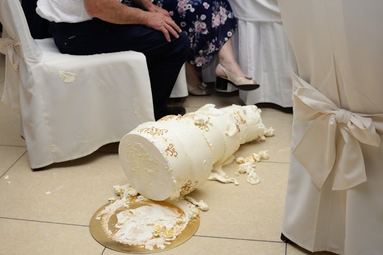 A wedding cake that has fallen to the floor