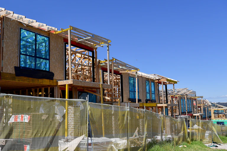 Row of timber-framed houses under construction